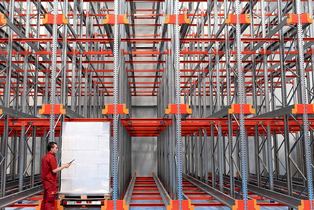 Radio shuttle carrier moving pallets inside a deep-lane high-density rack
